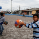 Children play at a basketball court covered with ash after Guatemala's Fuego volcano erupted violently, in Guatemala City, Guatemala June 3, 2018. REUTERS/ Luis Echeverria